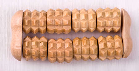 brown wooden bath massager  on the white wooden tableの写真素材