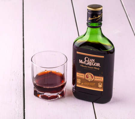 Kamchatka, Russia- OCT 26, 2016: whiskey from Scotland MacGregor and a glass with alcohol. Aged and especially soft Scotch whiskey. It is obtained by mixing the best fifteen Scotch whiskey with grain. The characteristic flavor of aged whiskey MacGregor taのeditorial素材