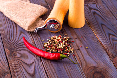 Black pepper corns, red hot chili pepper and Black pepper Powder on wooden backgroundの写真素材