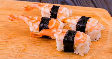 Sushi with shrimps on a wooden standの写真素材