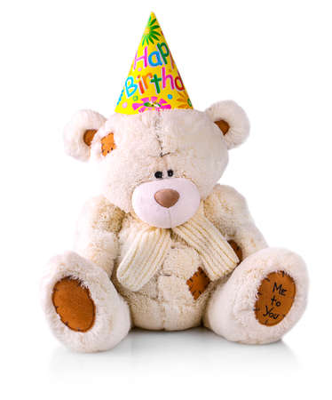 Teddy bear in a hat with the inscription "Happy birthday"の写真素材