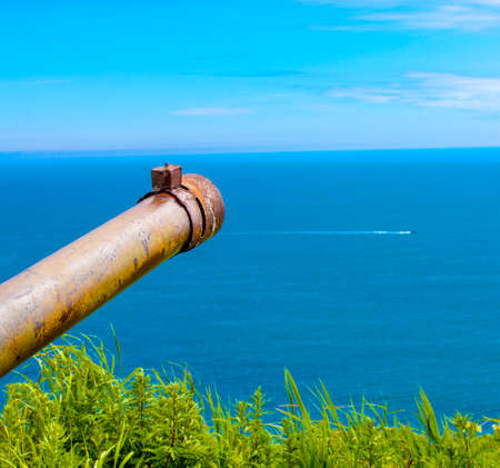 trunk of an old rusty military weapon on the coast of Kamchatkaの写真素材