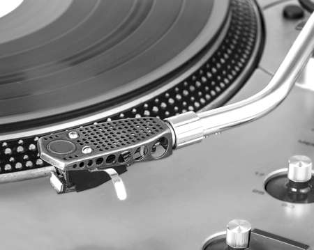 Old dusty vinyl turntable player isolated over white backgroundの写真素材