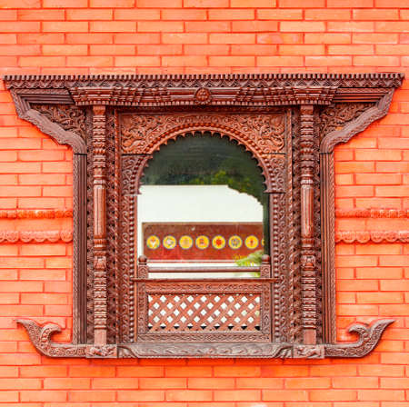 beautifull  window in red brick wall of a public Buddhist temple in China