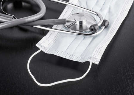 stethoscope on black wooden backgroundの写真素材