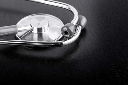 stethoscope on black wooden backgroundの写真素材