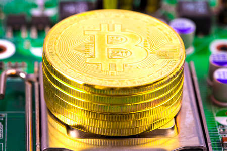 bitcoin concept - gold coin, computer circuit Board with bitcoin processor and microchips.の写真素材