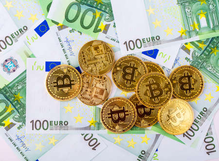 Background from bills of a hundred euros for bitcoins and goldの写真素材