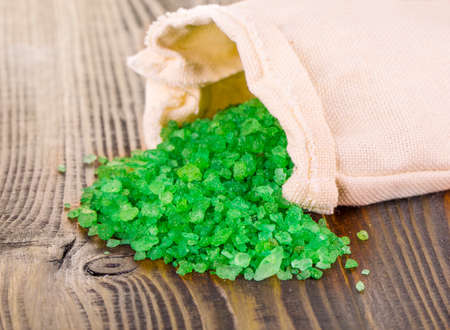 green bath salt in bag  on wooden surface の写真素材
