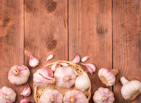 Cloves of garlic on wooden background,  concept healthy lifestyle.