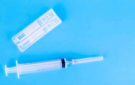 Medical vials and Syringe, Isolated on Blue backgroundÑ Copy space for textの写真素材
