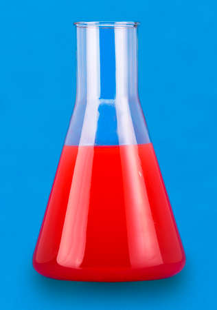Test flask with red liquid on blue backgroundの写真素材