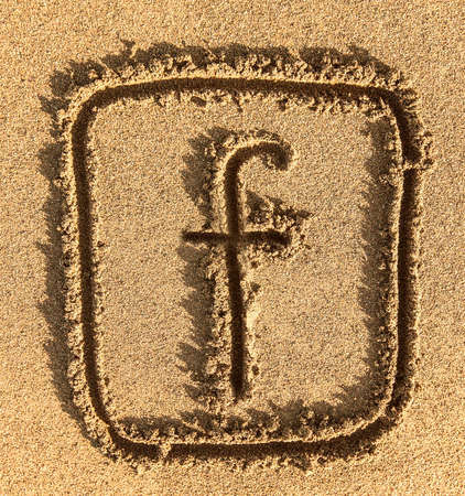 KAMCHATKA, RUSSIA - SEPTEMBER 16, 2018: 
Social network facebook sign in the sand on the Pacific coast, Kamchatka.のeditorial素材