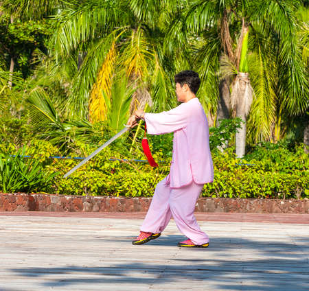 Sanya, China : 11 NOV 2017: Women  in the street in the Park gymnastics WUSHU.