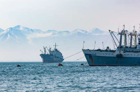 large fishing vessel on the background of hills and volcanoesの写真素材