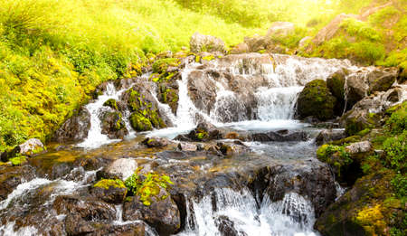 River stream flowing over rock formations in the mountains