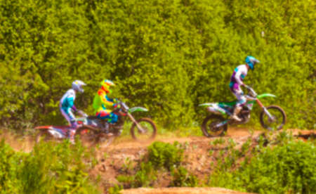 Motocross riders practice tricks  on their dirt bikes on a sunny day in Kamchatka. Blure backgroundの写真素材