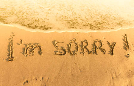 the inscription on the heat yellow sand  I m sorryの写真素材