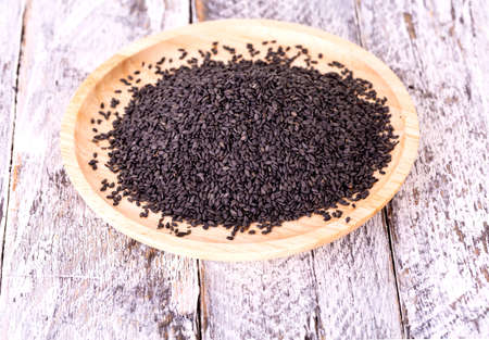 Close up of black sesame seed on wooden plate