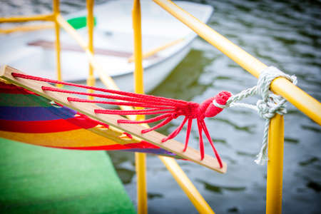 backyard rope hammock held by metal railing