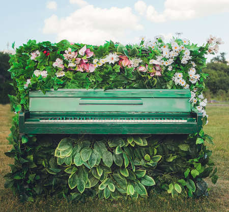 the old piano in beautiful flowers. Select focusの写真素材