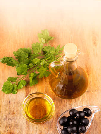 the olives and olive oil on wooden tableの写真素材