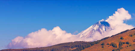 The Panoramic view of snow volcano and blue skyの写真素材