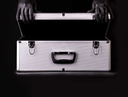 The large aluminum suitcase and hands black safety glovesの写真素材