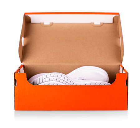 New white sneakers shoes in red box. Taken at studio and isolated over white background