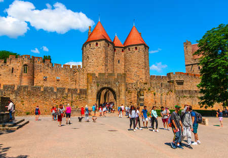 Carcassonne, France-06 19, 2018: Group of people in front of the main entrance of the fortified city of carcassonne,wich was restored in 1835 and added to the UNESCO list world heritage sites in 1997.のeditorial素材