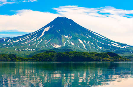The Picturesque summer reflection of Ilyinsky volcano in the Kurile lake water. South Kamchatka Sanctuary, Russiaの写真素材