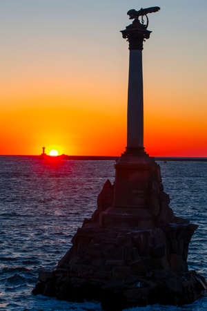 The sunset on the embankment of Sevastopol. The symbol of Sevastopol is a Monument to sunken ships, a historical memorial.の写真素材
