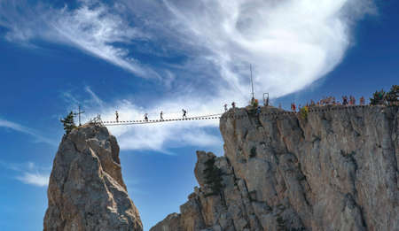 Beautiful landscape with mountains, rope ladder and blue sky.の写真素材