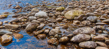 stones in a mountain river. Wild nature. Selective focusの写真素材