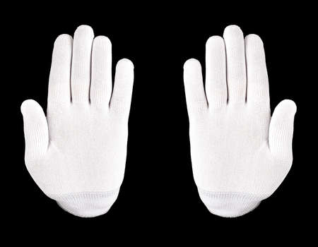 white gloved hand on a black background. A hand in a white glove shows stop sign on a black backgroundの写真素材