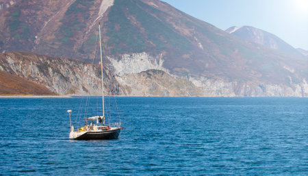 The Kamchatka peninsula. Pacific coast. Sailing yacht ship in the bay. Selective focus
