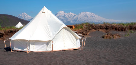 Glamping house in summer and volcano, rural landscape, tent houses in Kamchatka peninsulaの写真素材