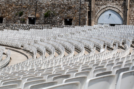 empty auditorium with gray plastic chairs in an ancient amphitheaterの写真素材