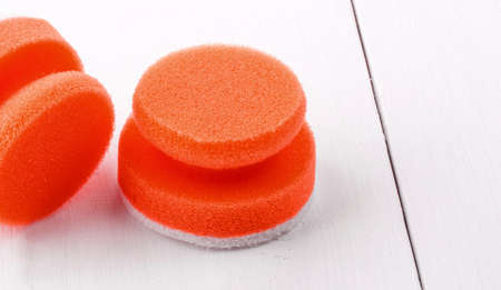 red sponges for washing dishes on white wooden backgroud