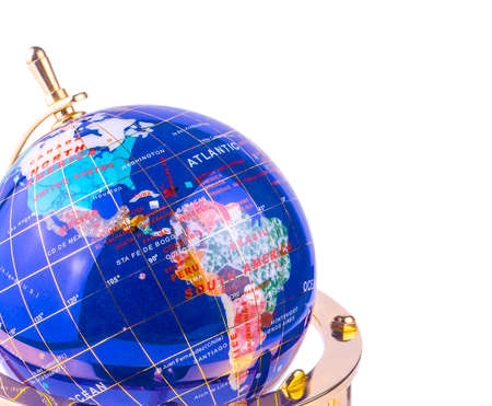 blue glass globe on the yellow shiny metal stand isolated on white backgroundの写真素材