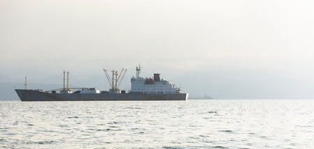 fishing trawler in the Bay on the roads in Kamchatka peninsulaの写真素材
