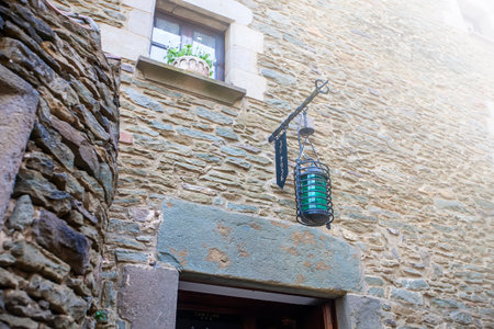 Old original lamp on the stone wall of the castle