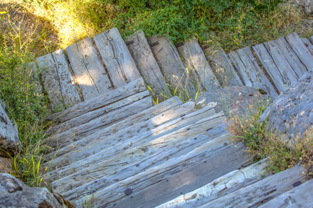 The zigzag old wooden stairs in the park top view