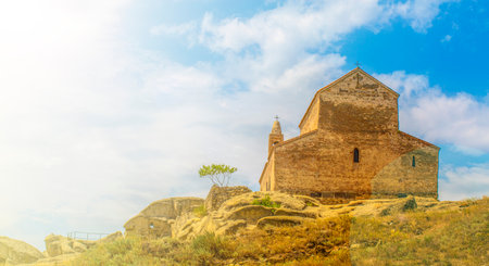 The back wall of old orthodox temple and blue sky in Georgiaの写真素材
