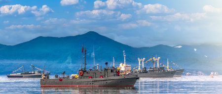 Warships in the maritime parade on bay on Pacific ocean on Kamchatka peninsula