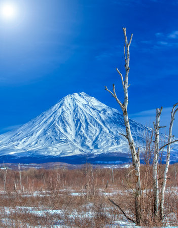 Koryaksky volcano in Kamchatka and the blue sky with sunlightの写真素材
