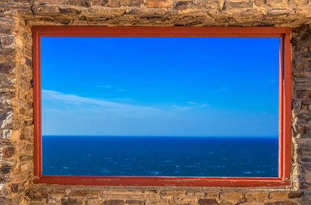 Mediterranean Sea view through old stone window, Spainの写真素材