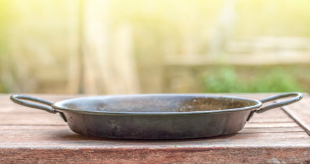 Cooking composition of the old cooking Frying pan over the wooden table on sunlightの写真素材