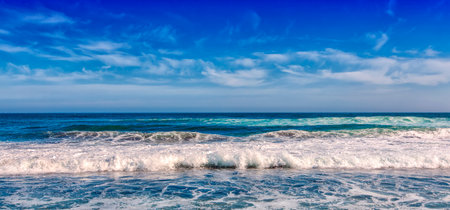 Big breaking Ocean wave on a black sandy beach on Pacific ocean