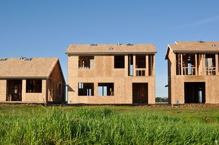 Three Homes Under Construction with Blue Skyの写真素材
